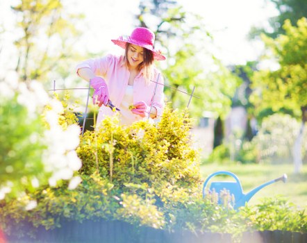 Operative wearing PPE performing garden work, showcasing safety compliance